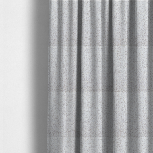 The fabric used to create these made-to-measure curtains is a light cool-toned grey and white blend textured upholstery fabric.