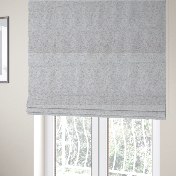 The fabric used to create these Roman blinds is a light cool-toned grey and white blend textured upholstery fabric.