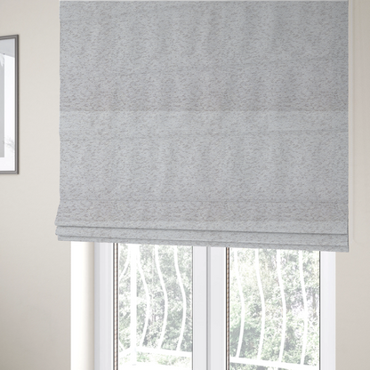 The fabric used to create these Roman blinds is a light cool-toned grey and white blend textured upholstery fabric.