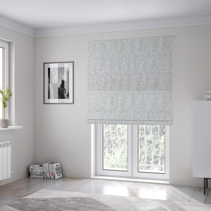 The fabric used to create these Roman blinds is a light cool-toned grey and white blend textured upholstery fabric.