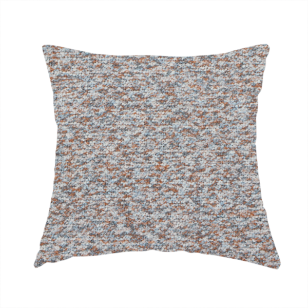 The fabric used to create these handmade cushions is a muted blue-grey and earthy terracotta mixed textured upholstery fabric.