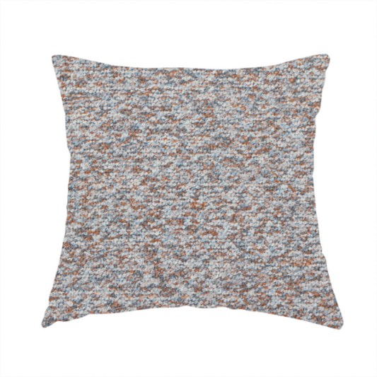 The fabric used to create these handmade cushions is a muted blue-grey and earthy terracotta mixed textured upholstery fabric.