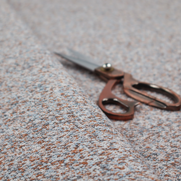 A muted blue-grey and earthy terracotta mixed textured upholstery fabric.