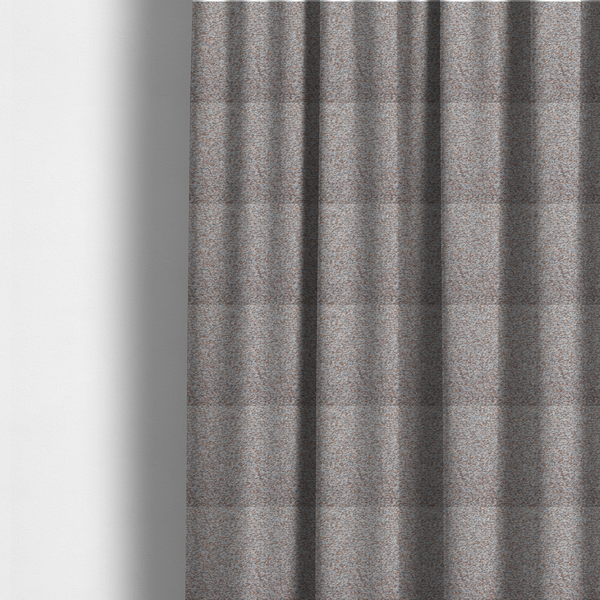 The fabric used to create these made-to-measure curtains is a muted blue-grey and earthy terracotta mixed textured upholstery fabric.