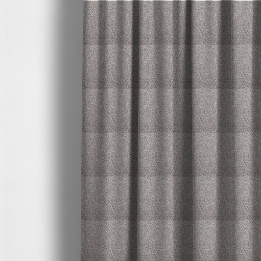 The fabric used to create these made-to-measure curtains is a muted blue-grey and earthy terracotta mixed textured upholstery fabric.