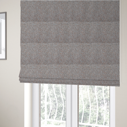 The fabric used to create these Roman blinds is a muted blue-grey and earthy terracotta mixed textured upholstery fabric.