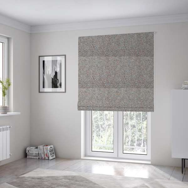 The fabric used to create these Roman blinds is a muted blue-grey and earthy terracotta mixed textured upholstery fabric.