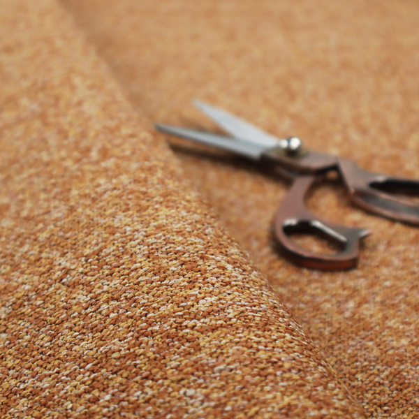 A rich mustard yellow and dark brown textured upholstery fabric.