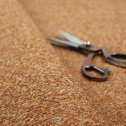 A rich mustard yellow and dark brown textured upholstery fabric.