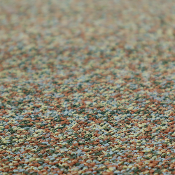 An earthy blend of forest green, terracotta, and grey textured upholstery fabric.