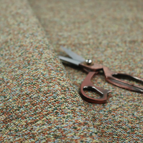 An earthy blend of forest green, terracotta, and grey textured upholstery fabric.