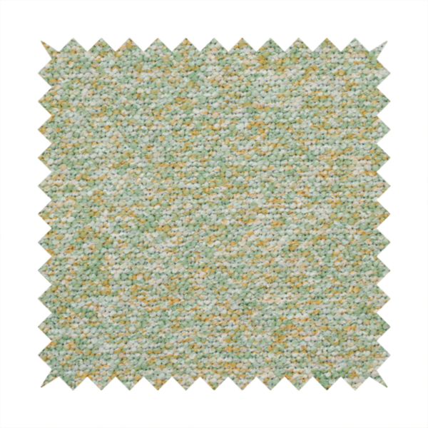 A pale sage green, soft yellow, and white textured upholstery fabric.