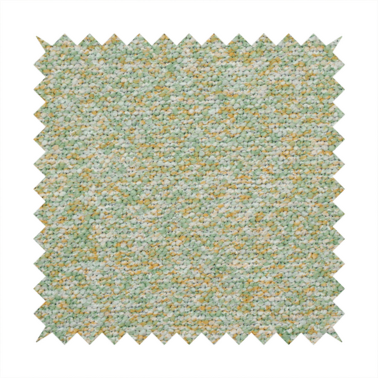 A pale sage green, soft yellow, and white textured upholstery fabric.