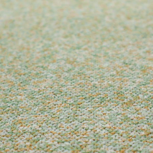 A pale sage green, soft yellow, and white textured upholstery fabric.