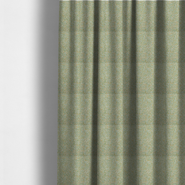 The fabric used to create these made-to-measure curtains is a pale sage green, soft yellow, and white textured upholstery fabric.