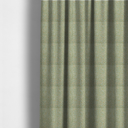 The fabric used to create these made-to-measure curtains is a pale sage green, soft yellow, and white textured upholstery fabric.