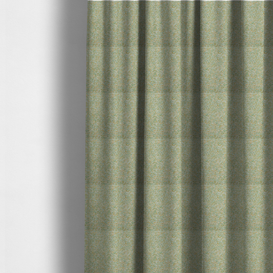 The fabric used to create these made-to-measure curtains is a pale sage green, soft yellow, and white textured upholstery fabric.