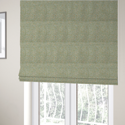 The fabric used to create these Roman blinds is a pale sage green, soft yellow, and white textured upholstery fabric.