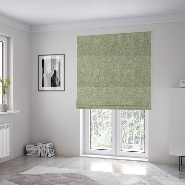 The fabric used to create these Roman blinds is a pale sage green, soft yellow, and white textured upholstery fabric.