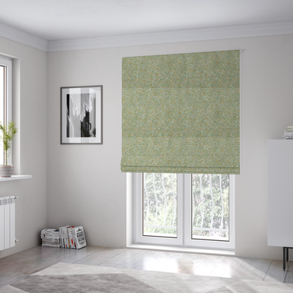 The fabric used to create these Roman blinds is a pale sage green, soft yellow, and white textured upholstery fabric.