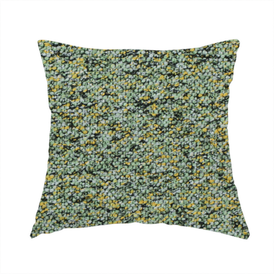 The fabric used to create this handmade cushion is a high-contrast lime green, dark green, and yellow textured upholstery fabric.
