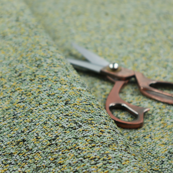 A high-contrast lime green, dark green, and yellow textured upholstery fabric.