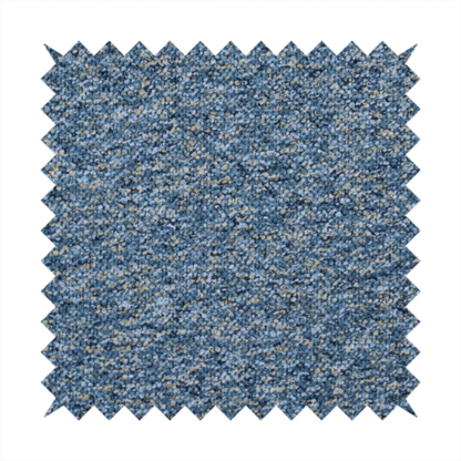 A  mid-tone blue textured upholstery fabric with subtle cream and yellow flecks.