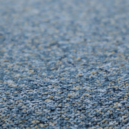 A mid-tone blue textured upholstery fabric with subtle cream and yellow flecks.
