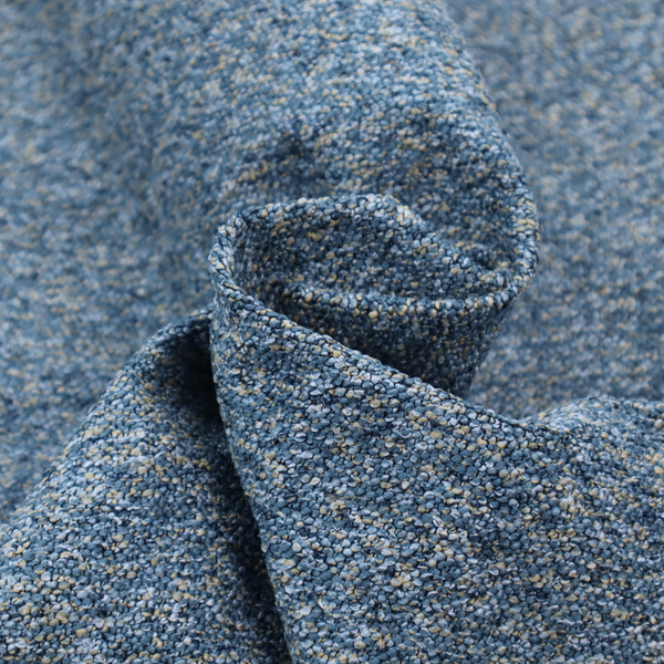 A mid-tone blue textured upholstery fabric with subtle cream and yellow flecks.