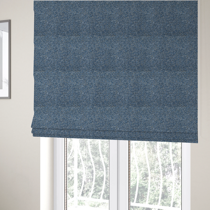 The fabric used to create these Roman blinds is a mid-tone blue textured upholstery fabric with subtle cream and yellow flecks.