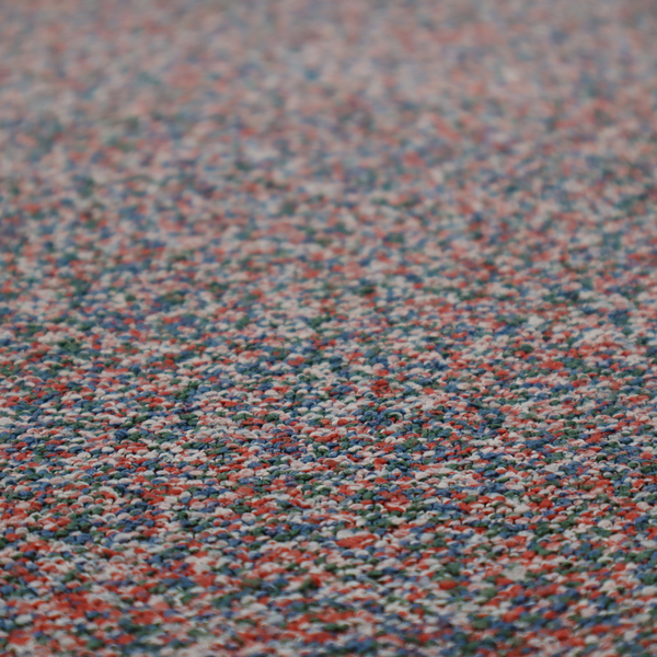 A multi-coloured textured upholstery fabric, featuring a blend of red, blue, green, and white fibres.