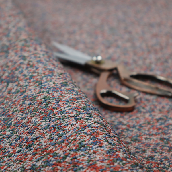 A multi-coloured textured upholstery fabric, featuring a blend of red, blue, green, and white fibres.