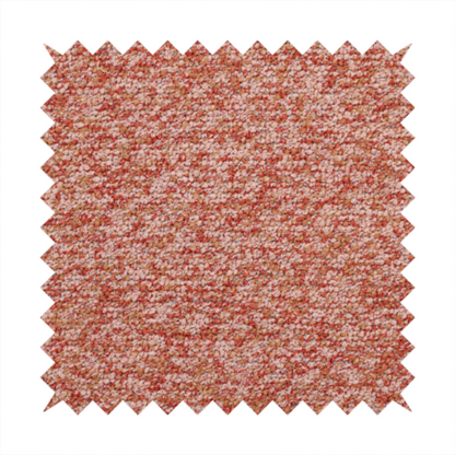 A soft coral and cream upholstery fabric featuring a detailed, textured, and nubby weave.