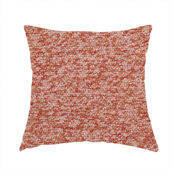 The fabric used to create this handmade cushion is a soft coral and cream upholstery fabric featuring a detailed, textured, and nubby weave.