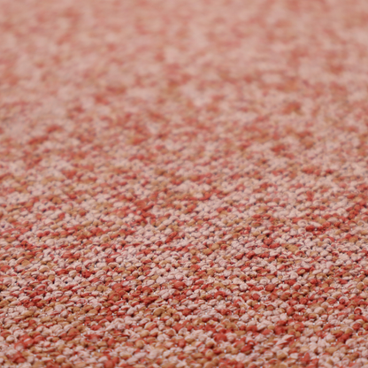 A soft coral and cream upholstery fabric featuring a detailed, textured, and nubby weave.