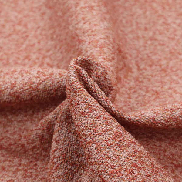 A soft coral and cream upholstery fabric featuring a detailed, textured, and nubby weave.