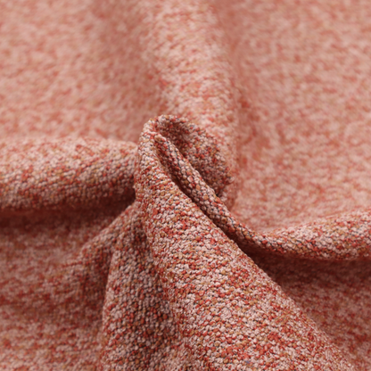 A soft coral and cream upholstery fabric featuring a detailed, textured, and nubby weave.