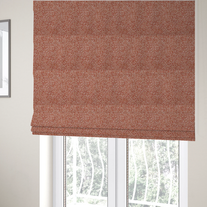 The fabric used to create these Roman blinds is a soft coral and cream upholstery fabric featuring a detailed, textured, and nubby weave.