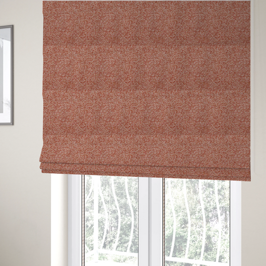 The fabric used to create these Roman blinds is a soft coral and cream upholstery fabric featuring a detailed, textured, and nubby weave.