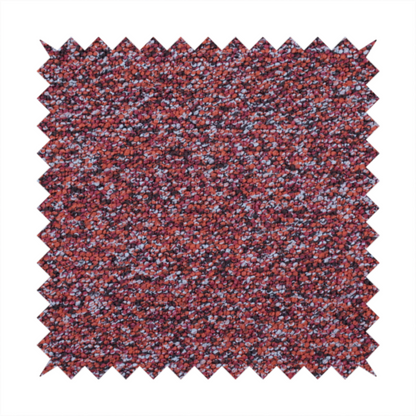 A warm, rustic red and deep terracotta upholstery fabric, showcasing a complex, nubby texture and rich colour variation.
