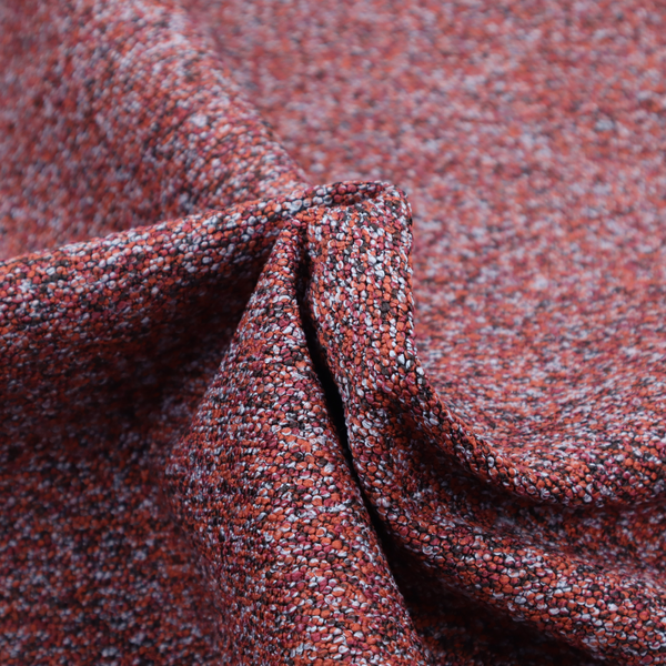 A warm, rustic red and deep terracotta upholstery fabric, showcasing a complex, nubby texture and rich colour variation.