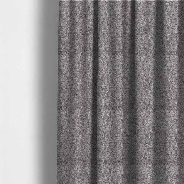 The fabric used to create these made-to-measure curtains is a dark charcoal and slate grey fabric with a dense, nubby weave. The heavy-duty, multi-tonal texture suggests a durable, high-quality material for furniture upholstery.