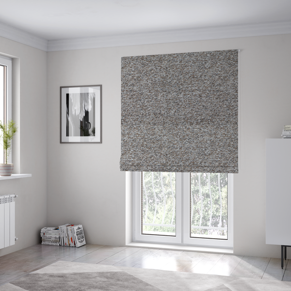 The fabric used to create these Roman blinds is a dark charcoal and slate grey fabric with a dense, nubby weave. The heavy-duty, multi-tonal texture suggests a durable, high-quality material for furniture upholstery.