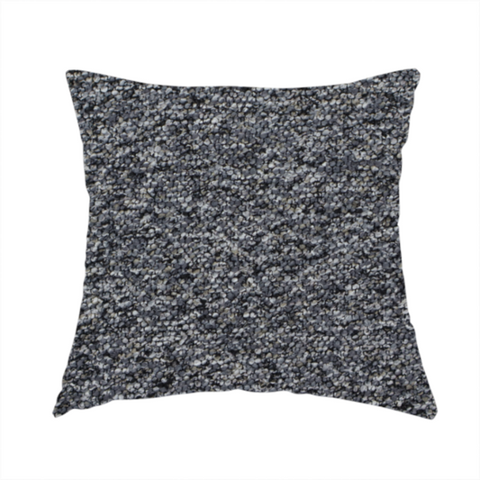 The fabric used to create this handmade cushion is a textured, nubby fabric surface in shades of charcoal, slate, and light grey. The speckled pattern suggests a durable, tightly woven material, ideal for upholstery.