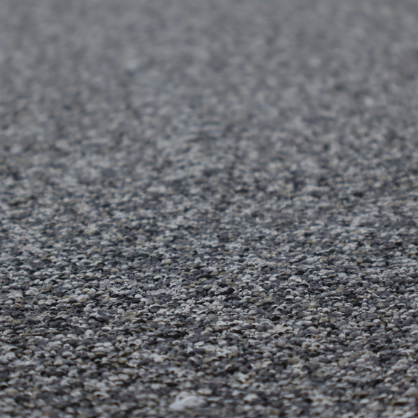 A textured, nubby fabric surface in shades of charcoal, slate, and light grey. The speckled pattern suggests a durable, tightly woven material, ideal for upholstery.