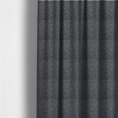 The fabric used to create these made-to-measure curtains is a textured, nubby fabric surface in shades of charcoal, slate, and light grey. The speckled pattern suggests a durable, tightly woven material, ideal for upholstery.