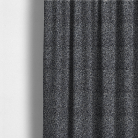 The fabric used to create these made-to-measure curtains is a textured, nubby fabric surface in shades of charcoal, slate, and light grey. The speckled pattern suggests a durable, tightly woven material, ideal for upholstery.