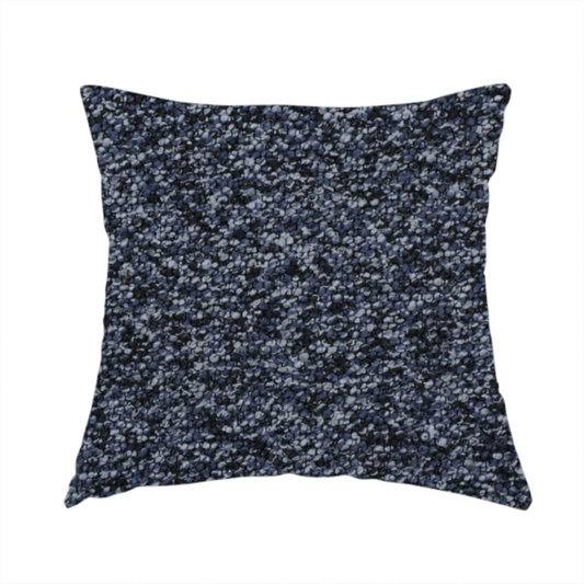 The fabric used to create this handmade cushion is a textured fabric surface. The material features a dense, nubby appearance with a speckled, multi-tonal colour palette of dark navy blue, charcoal, and light grey fibres, characteristic of heavy-duty carpeting or upholstery.