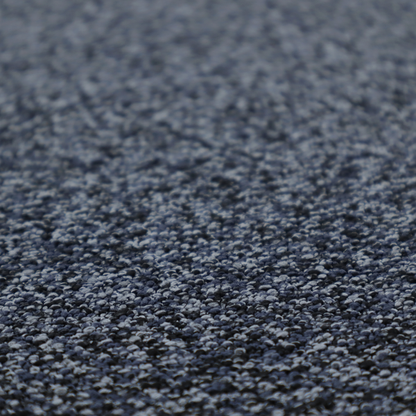 A textured fabric surface. The material features a dense, nubby appearance with a speckled, multi-tonal colour palette of dark navy blue, charcoal, and light grey fibres, characteristic of heavy-duty carpeting or upholstery.