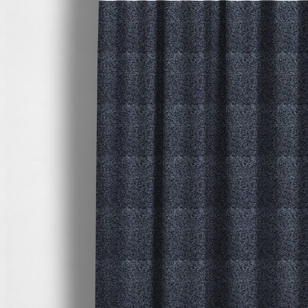 The fabric used to create these made-to-measure curtains is a textured fabric surface. The material features a dense, nubby appearance with a speckled, multi-tonal colour palette of dark navy blue, charcoal, and light grey fibres, characteristic of heavy-duty carpeting or upholstery.